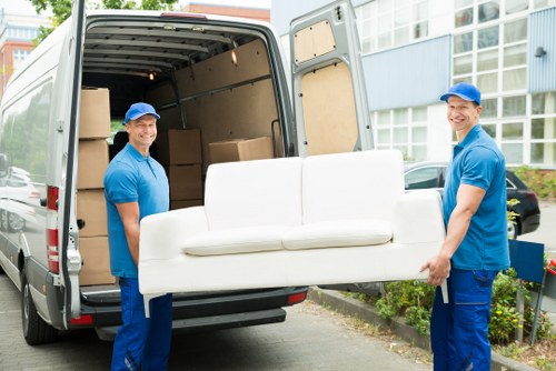 Team sorting recyclable moving materials at a Holland Park removals job