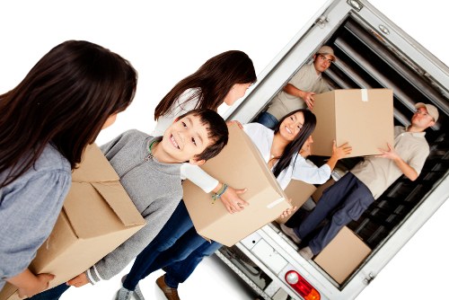 Removalist truck and moving boxes in a suburban street setting
