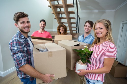 Removal van and moving team preparing a residential move in Holland Park