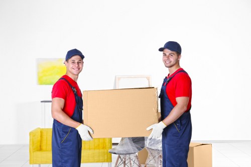 Removal team loading household furniture for a move in Holland Park