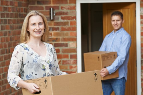 Boxes and furniture being loaded into a local removal van