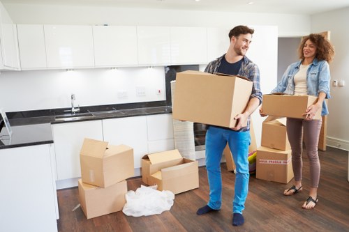 Removal team handling stairs and furniture in Hollandpark