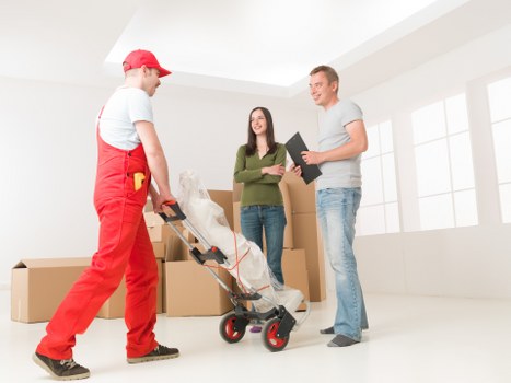 Movers handling office furniture and equipment carefully