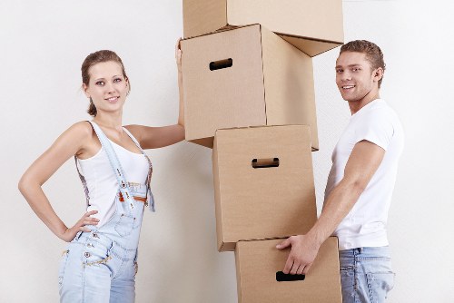 Professional movers handling fragile items and boxes during a local house move